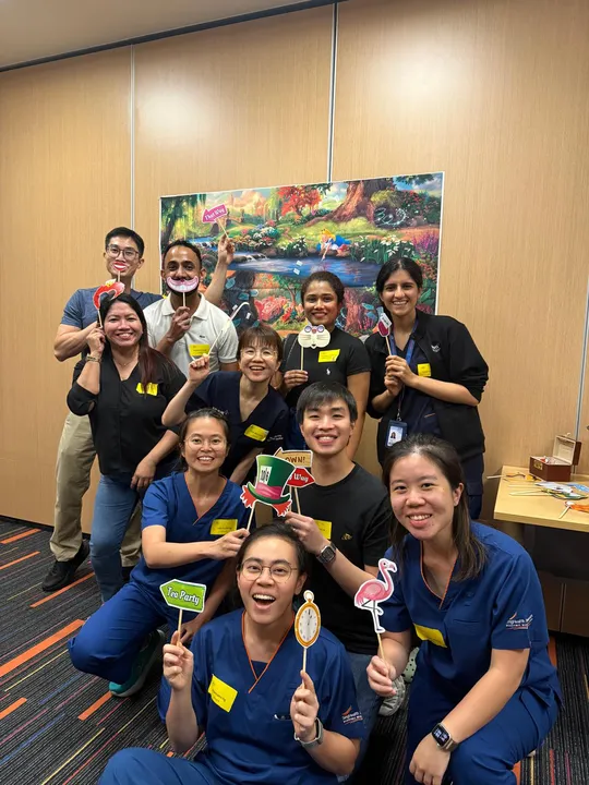 Participants and faculty group photo with props