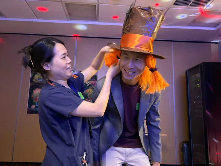 Faculty in Mad Hatter costume at the escape room