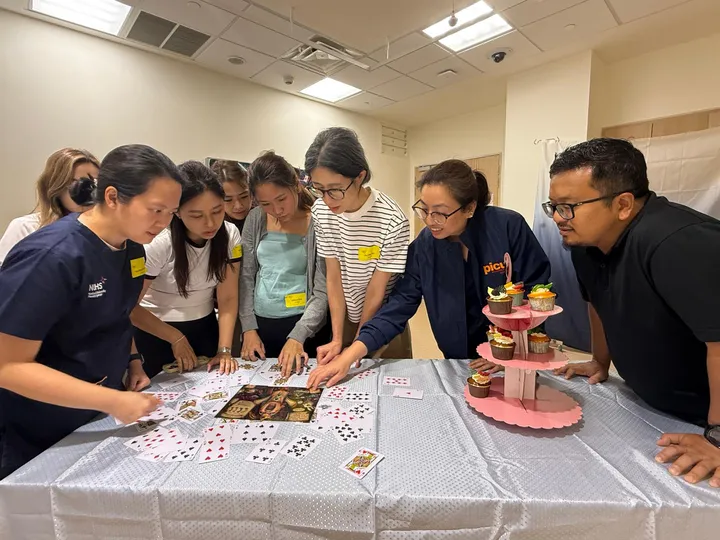 Teams solving the escape room card puzzle
